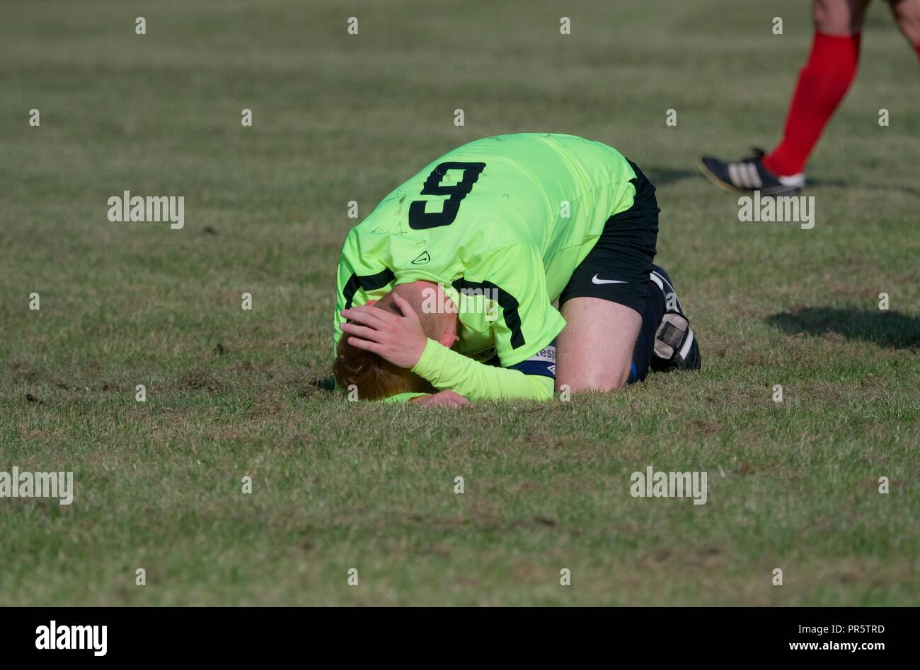 A player feigns a head injury in a match between Dove Holes and Buxworth Stock Photo Alamy