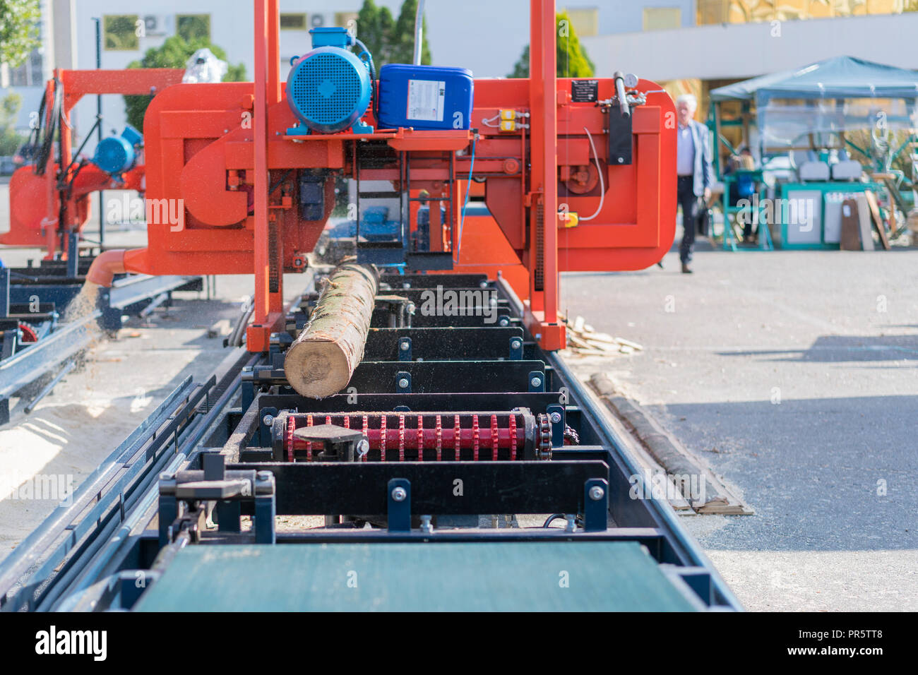 Partially milled log on a portable lumber milling machine Stock Photo