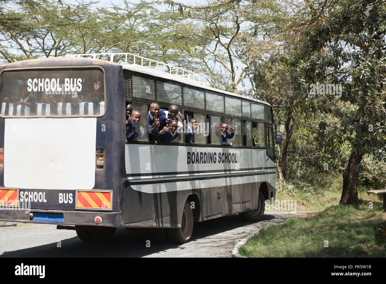 Nakuru, Kenya - October, 2016. African school children on their day trip to Nakuru National Park. Boarding school bus. Stock Photo