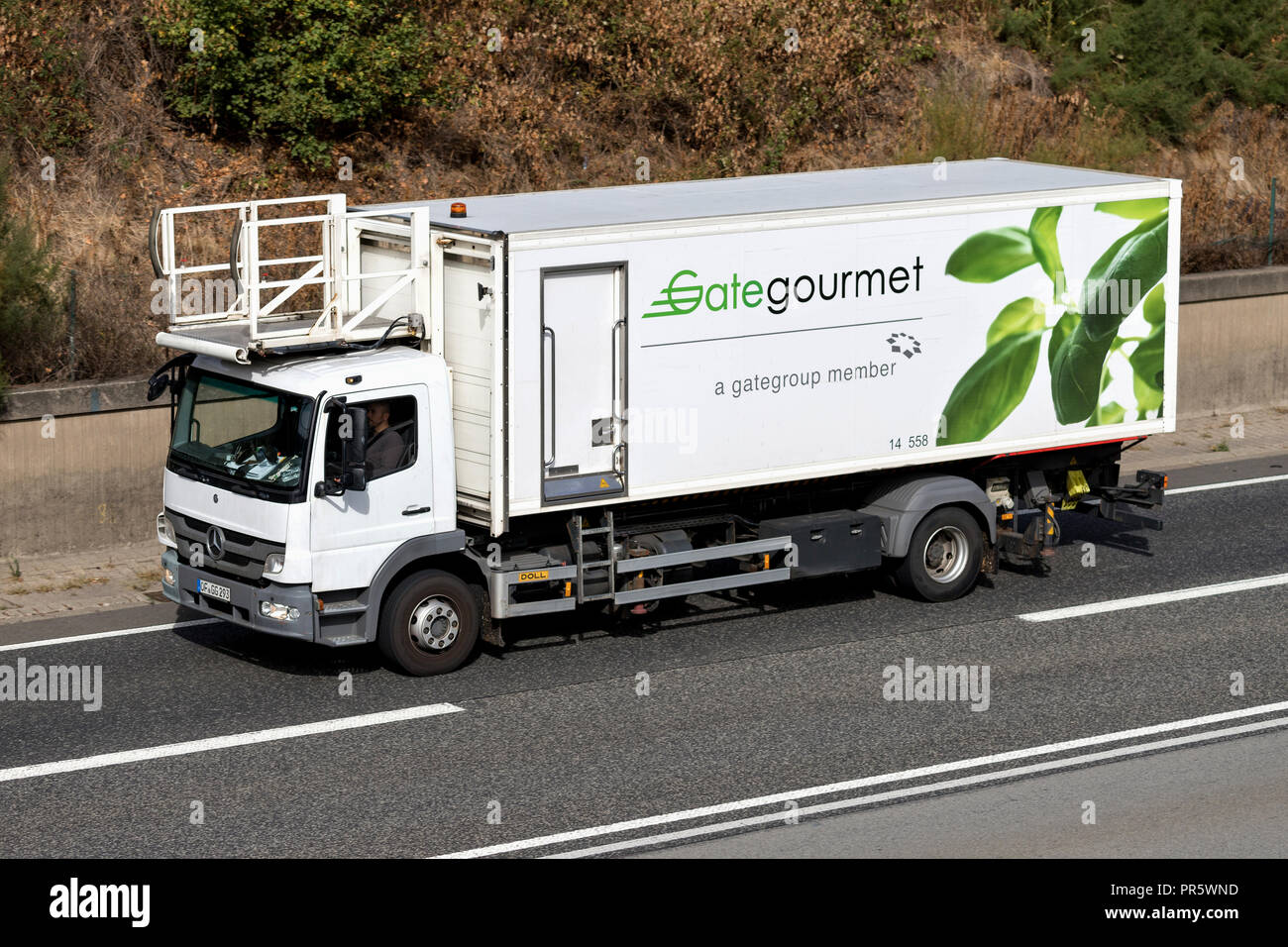 Gate Gourmet catering truck on motorway. Gate Gourmet is a leading global provider of airline catering and provisioning. Stock Photo