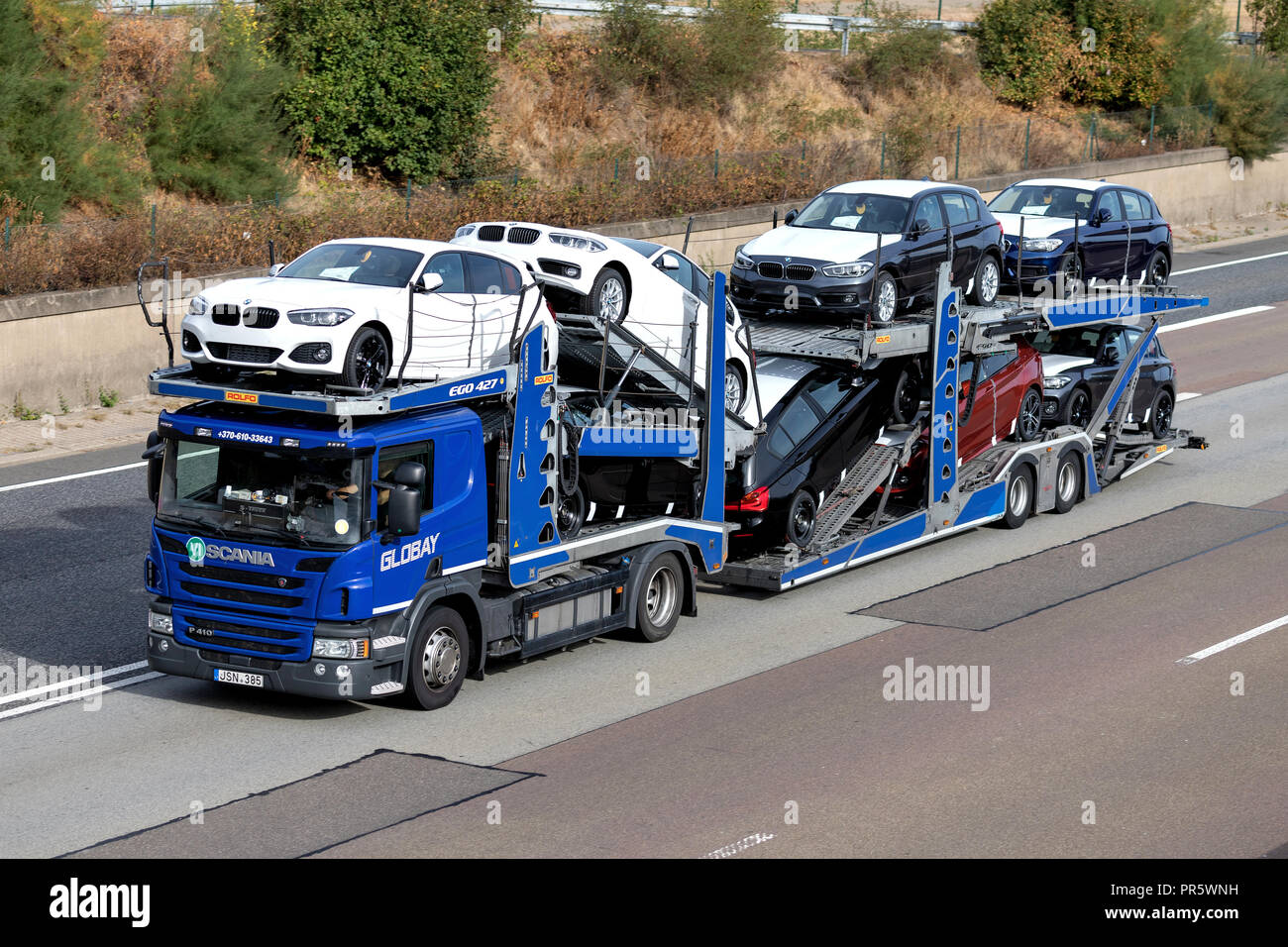 Globay truck on motorway. Globay is group of companies that provide automobile logistics solutions for car manufacturers, dealers and used car sellers Stock Photo