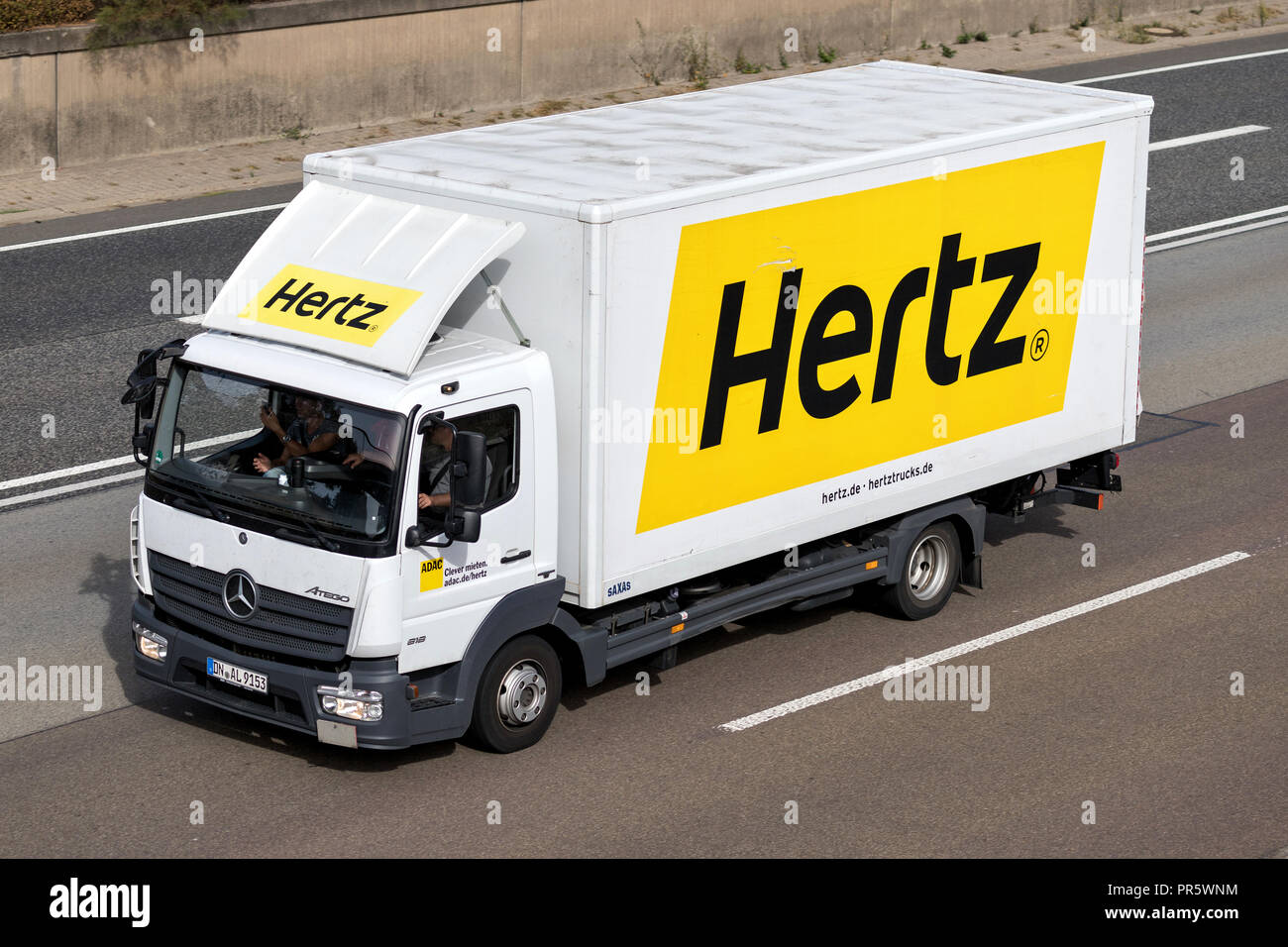Mercedes-Benz Atego of Hertz on motorway. The Hertz Corporation is an American car rental company based in Estero, Florida. Stock Photo