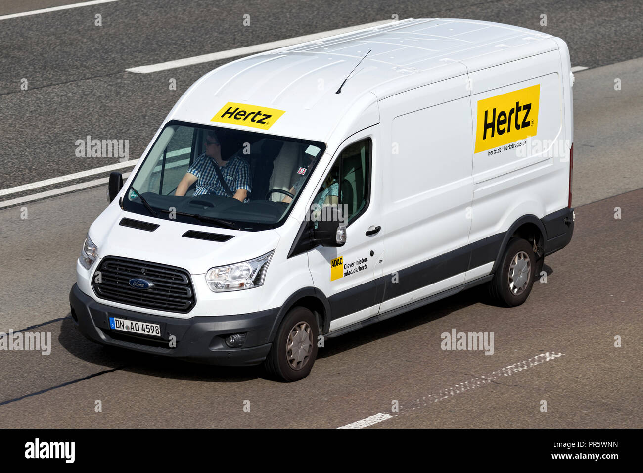 Ford Transit of Hertz on motorway. The Hertz Corporation is an American car rental company based in Estero, Florida. Stock Photo