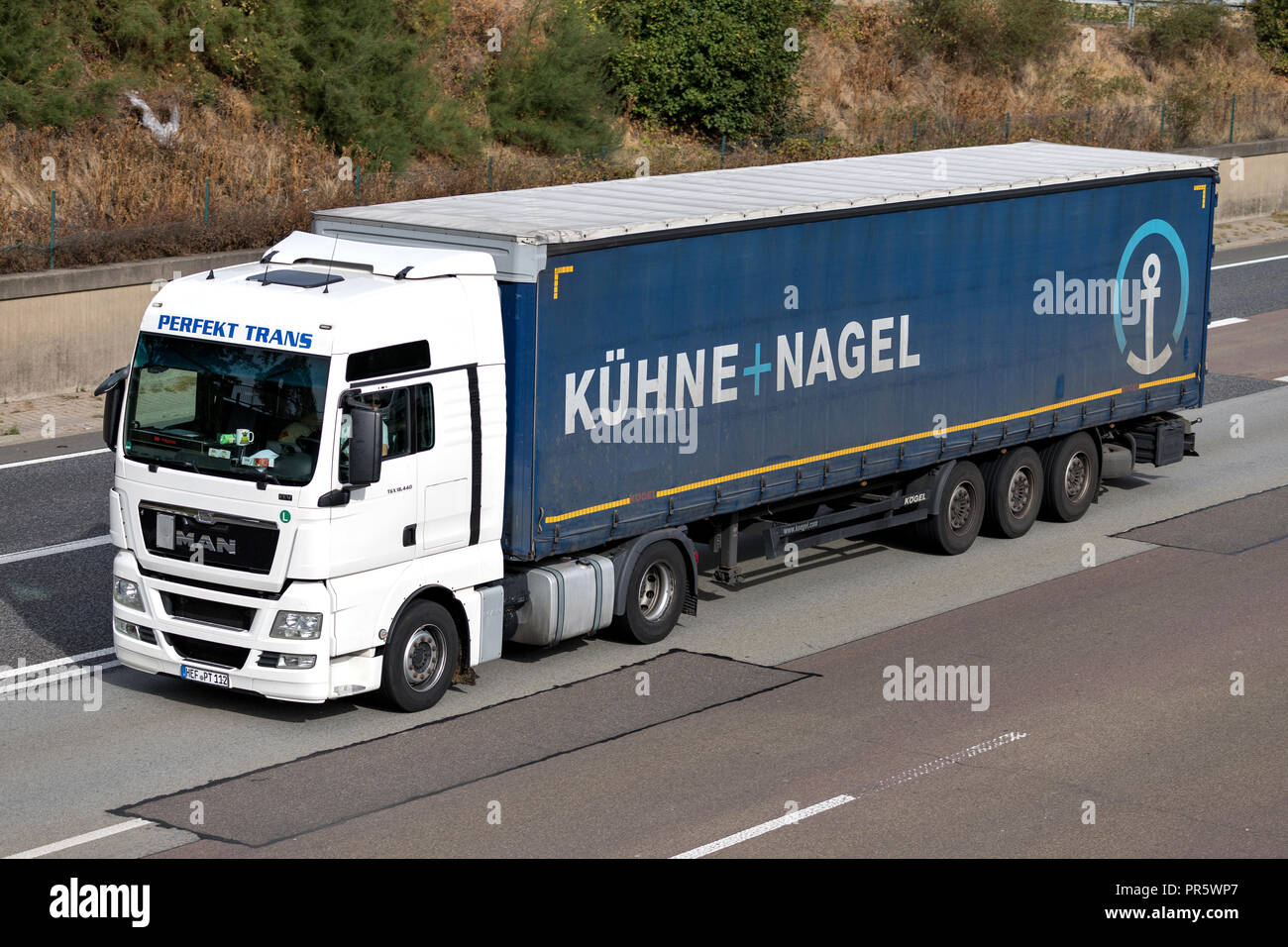 Kuehne + Nagel truck on motorway. Kuehne + Nagel International AG is a global transport and logistics company based in Schindellegi, Switzerland. Stock Photo