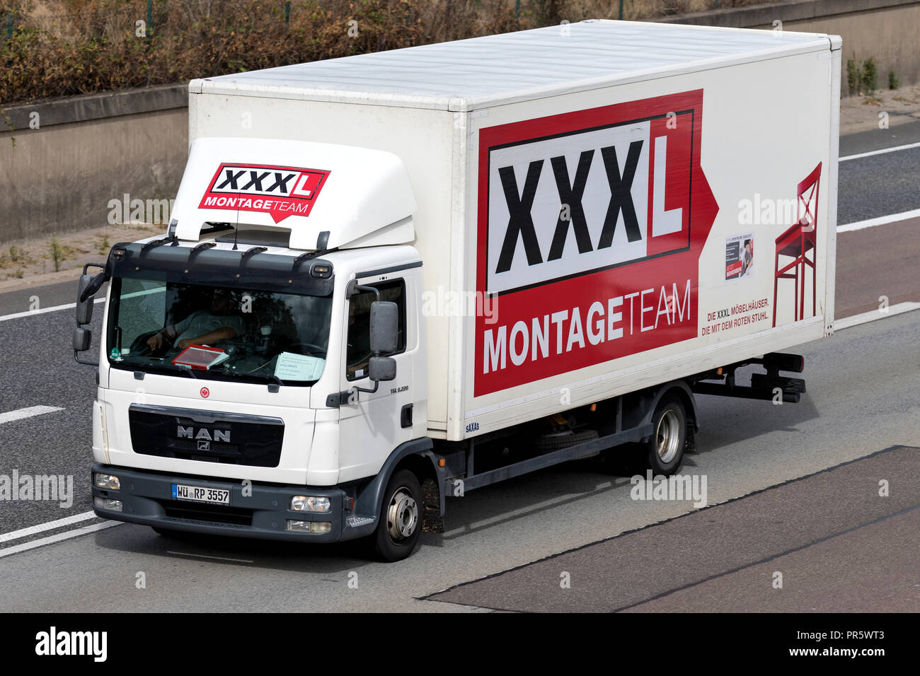 XXXL truck on motorway. Austria based XXXLutz is the second largest furniture retailer in the world. Stock Photo