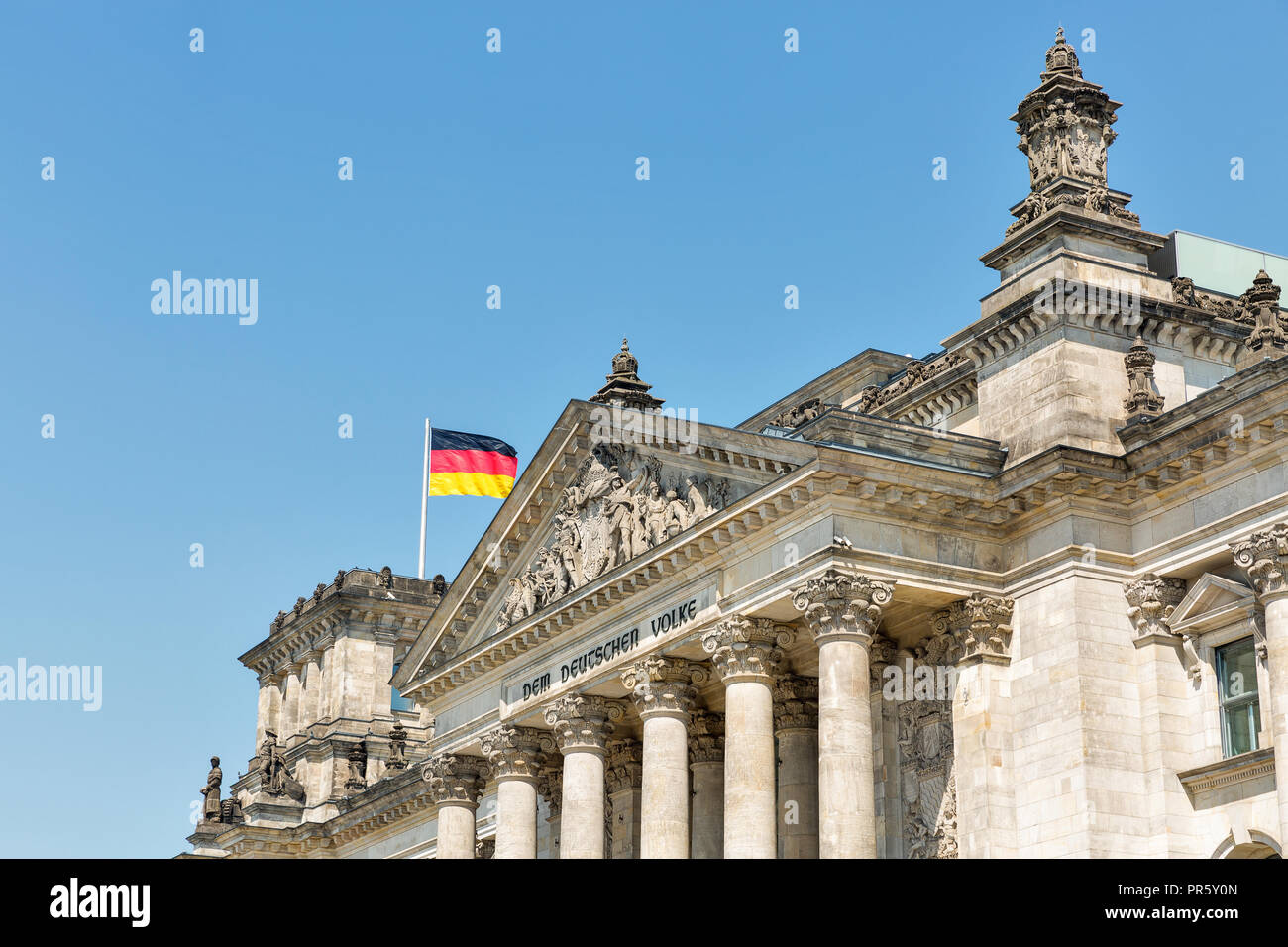 Closeup view of famous Reichstag building with German flag, seat of the German Parliament. Berlin Mitte district, Germany. Stock Photo