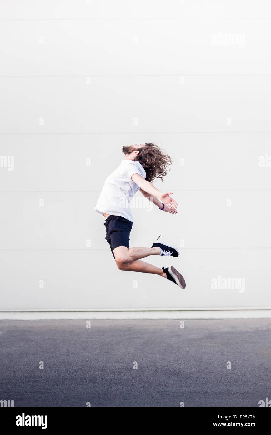 Young man in midair jump Stock Photo