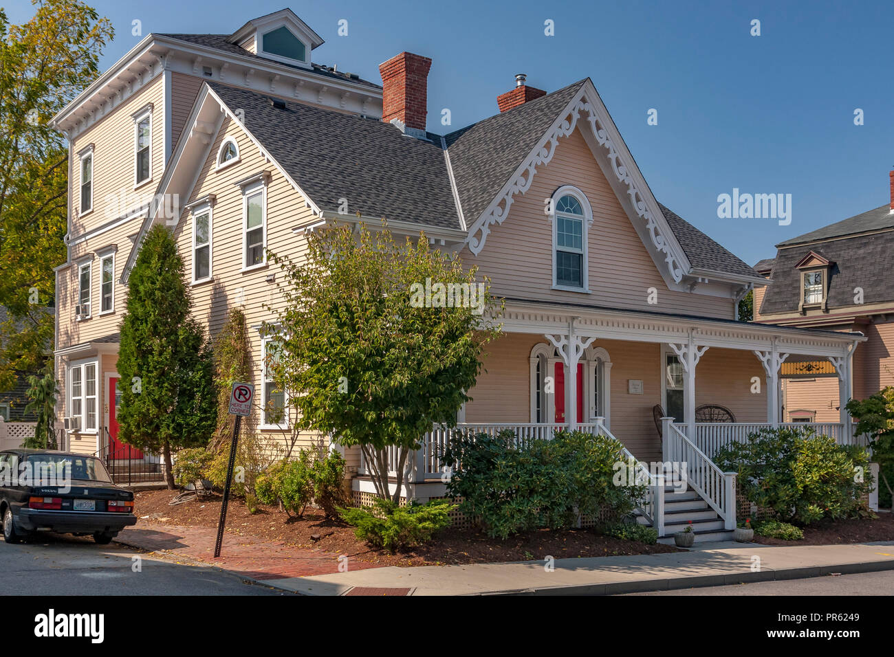 Pink gabled roof house with front porch and grey slate roof ,Bull St , Newport Rhode Island ,USA Stock Photo