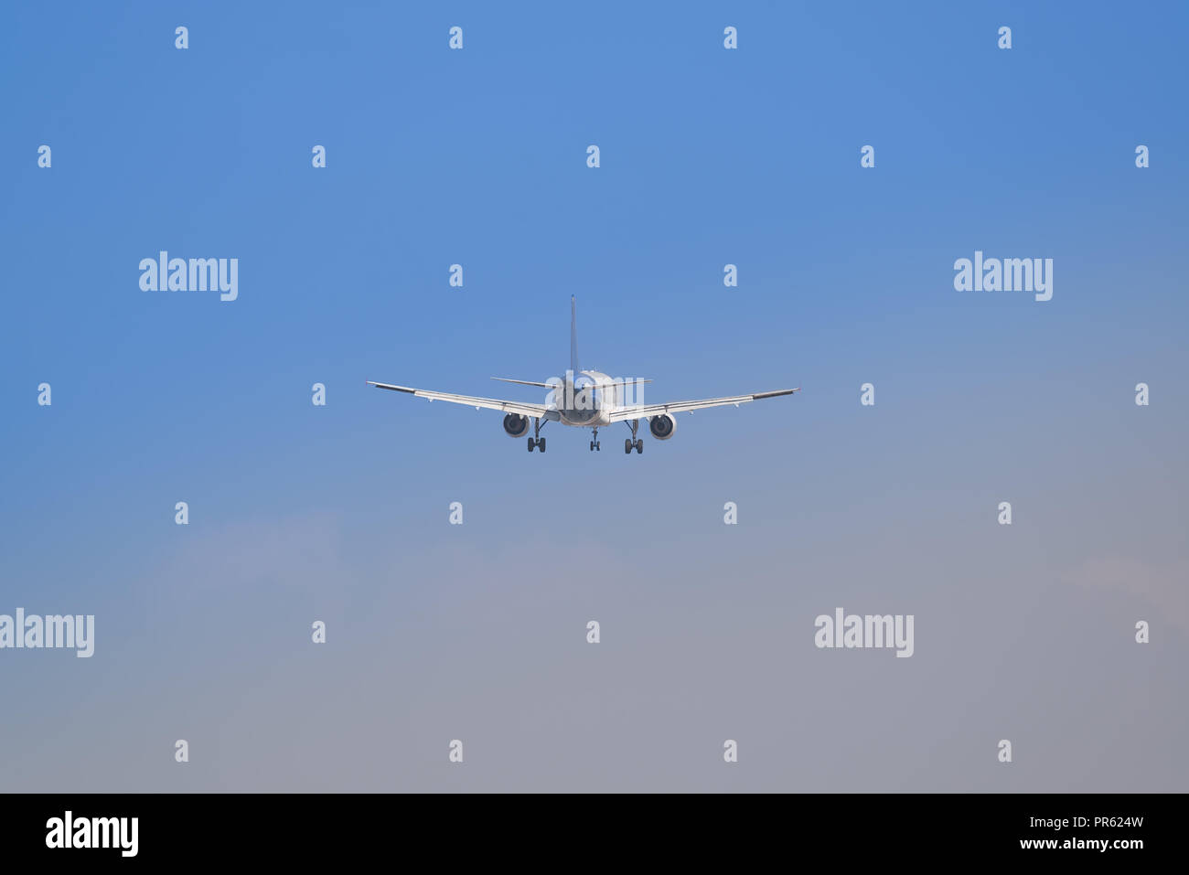 Big airplane flying high with detail of the land gear down Stock Photo