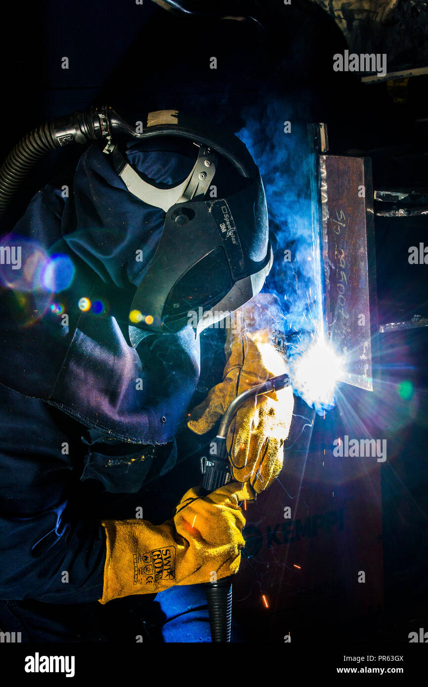 Welder wearing safety equipment welding Stock Photo Alamy