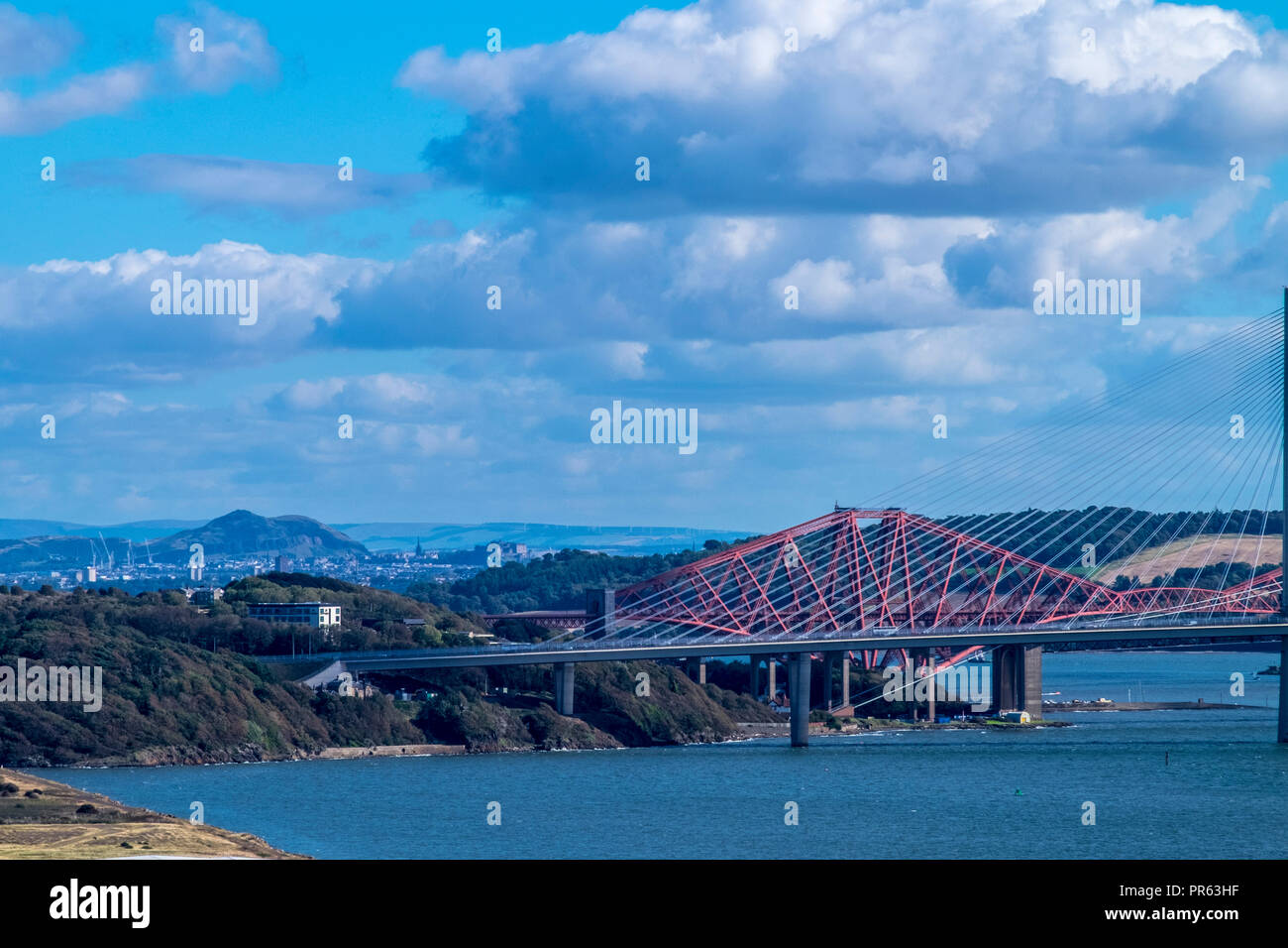 Forth Bridges with Arthurs Seat and Edinburgh Castle in the background Stock Photo