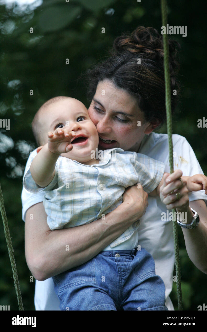 Mother and toddler on swing Stock Photo