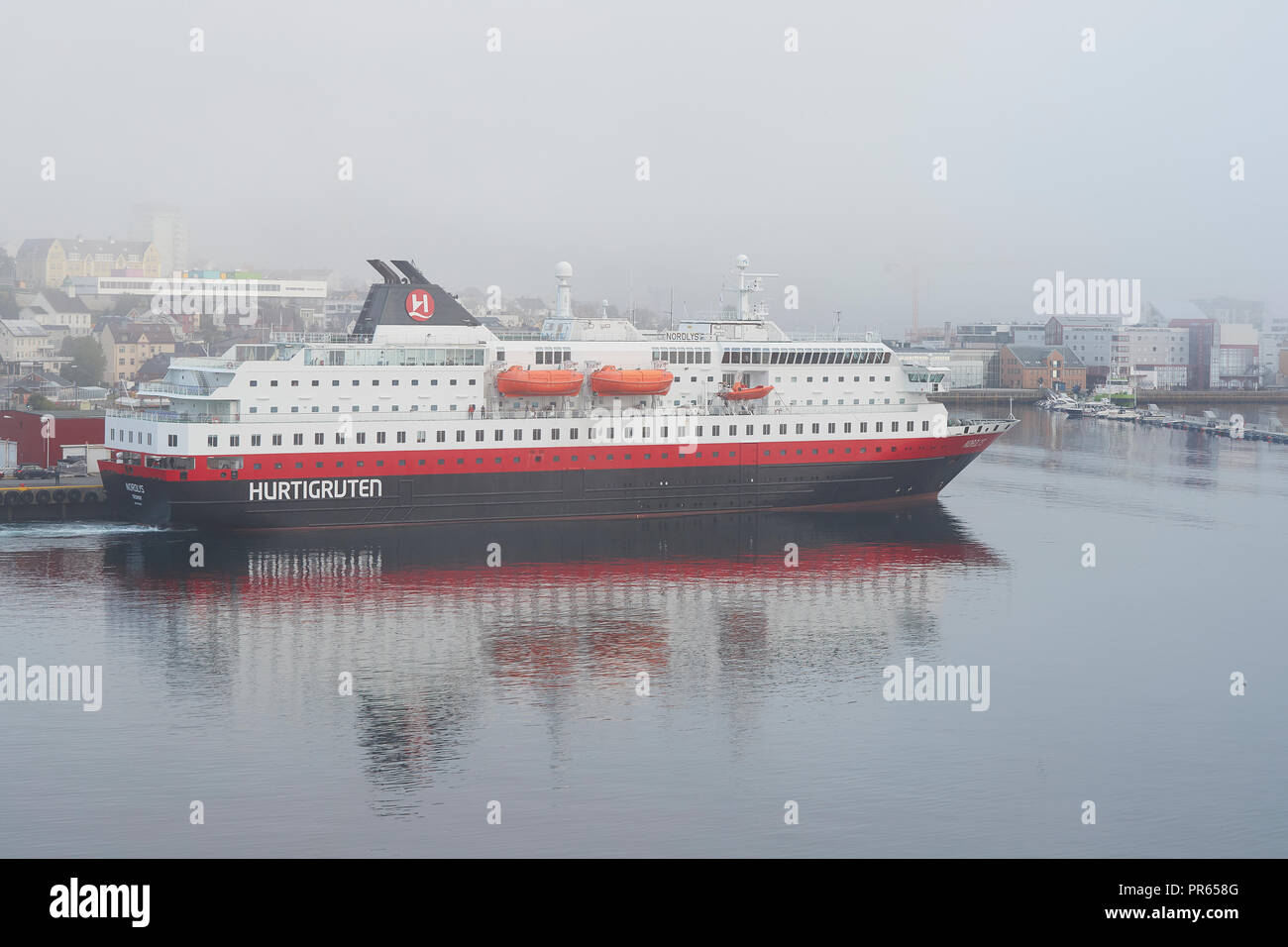 The Hurtigruten Ship, MS NORDLYS, Departing From Harstad, In A Thick September Morning Fog. Troms County, Norway. Stock Photo