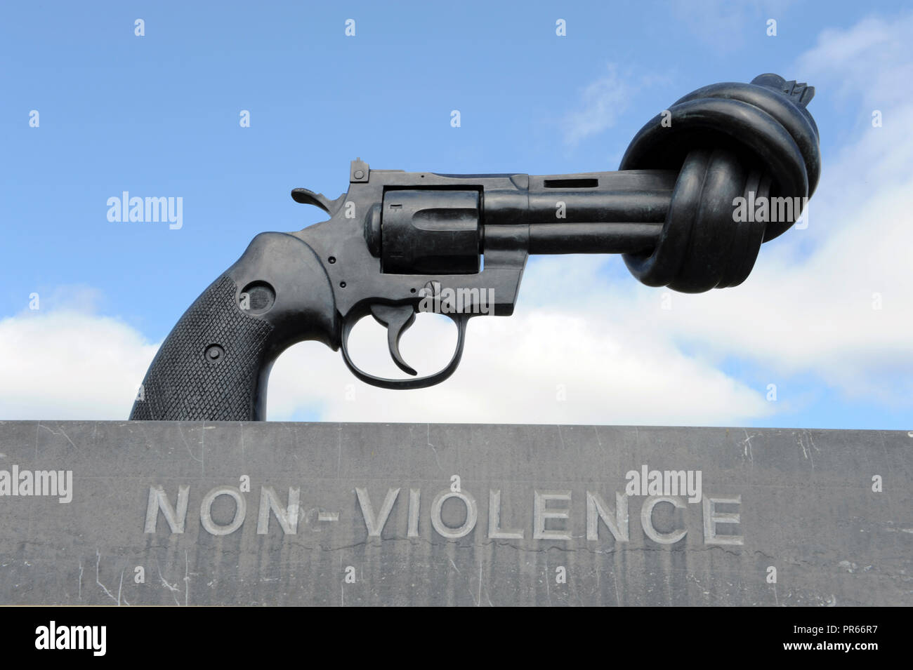 Metallic sculpture of a knotted gun representing non-violence campaign at world war II D Day Normandy beach France Europe Stock Photo