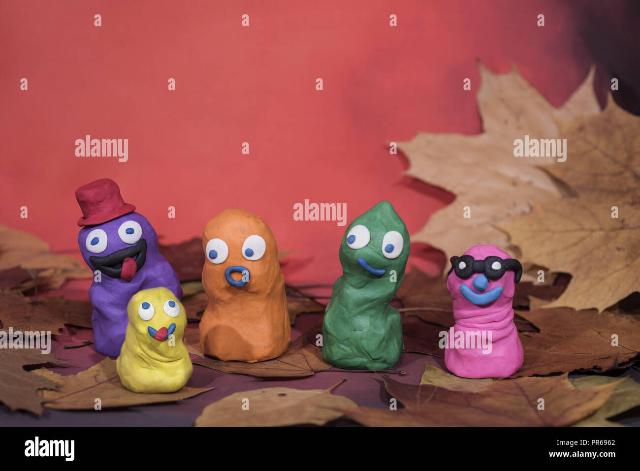 Small funny figures made from Play Clay. Autumn abstraction Stock Photo -  Alamy