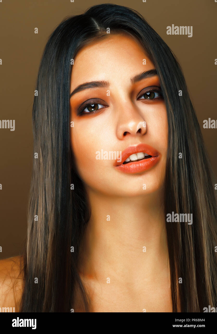 Young Pretty Indian Girl Posing Emotional On Brown Background L