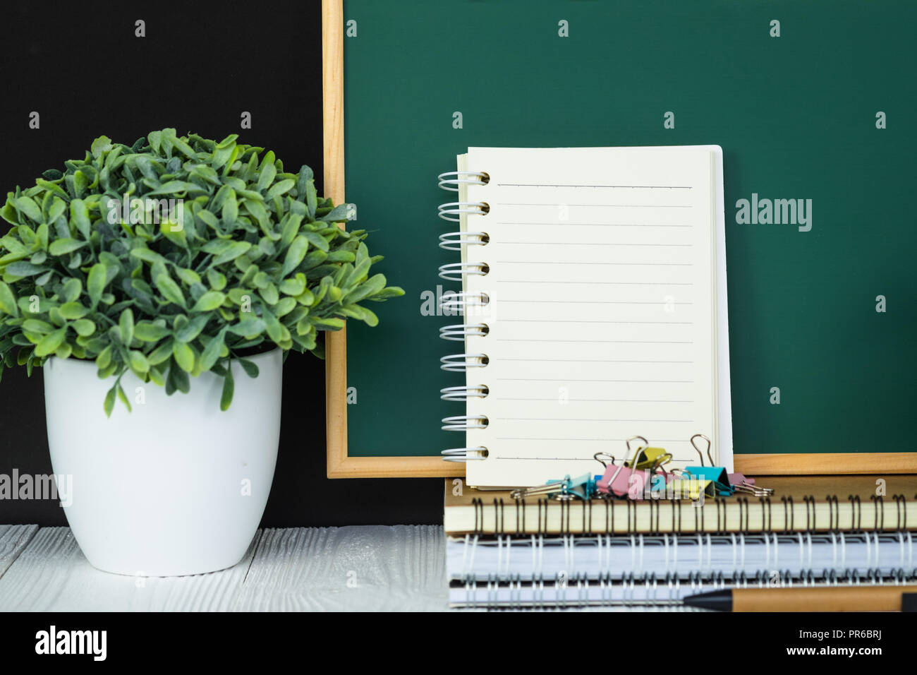 Back to school and education concept idea, green chalkboard with pile ...