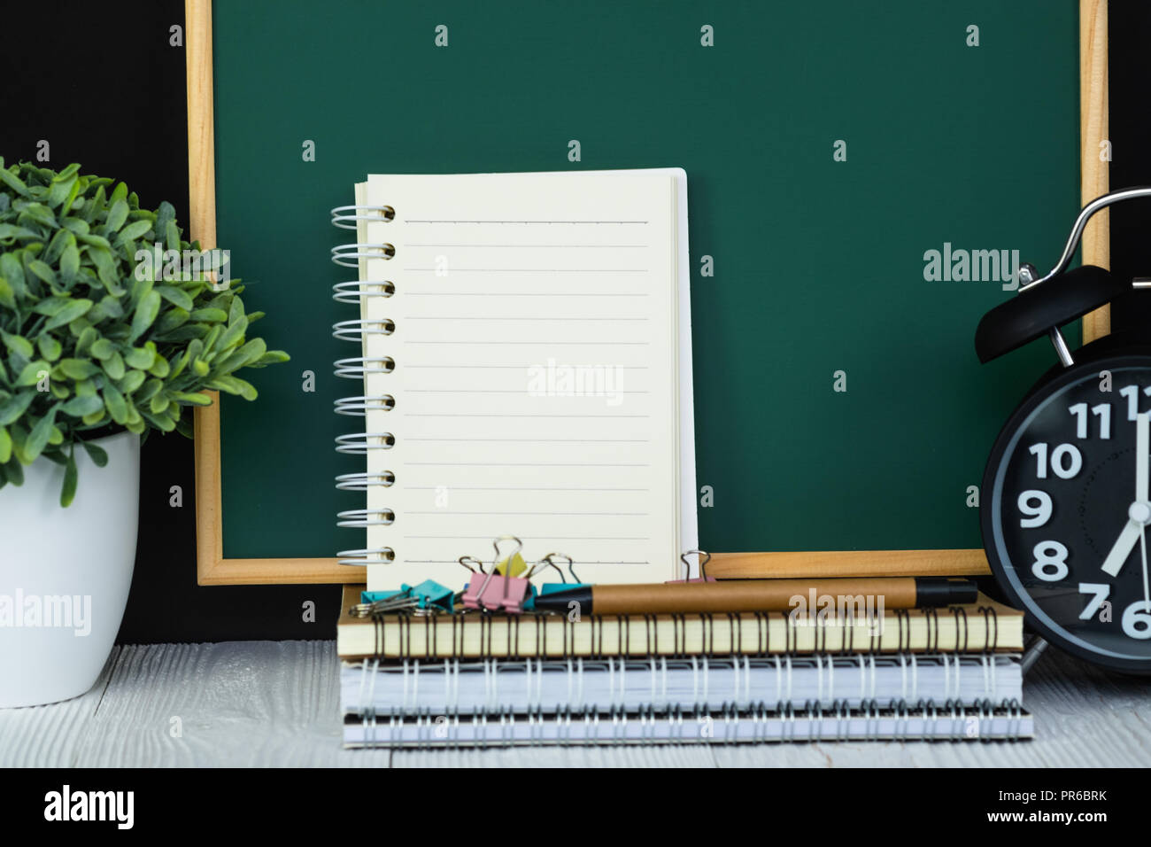 Back to school and education concept idea, green chalkboard with pile ...