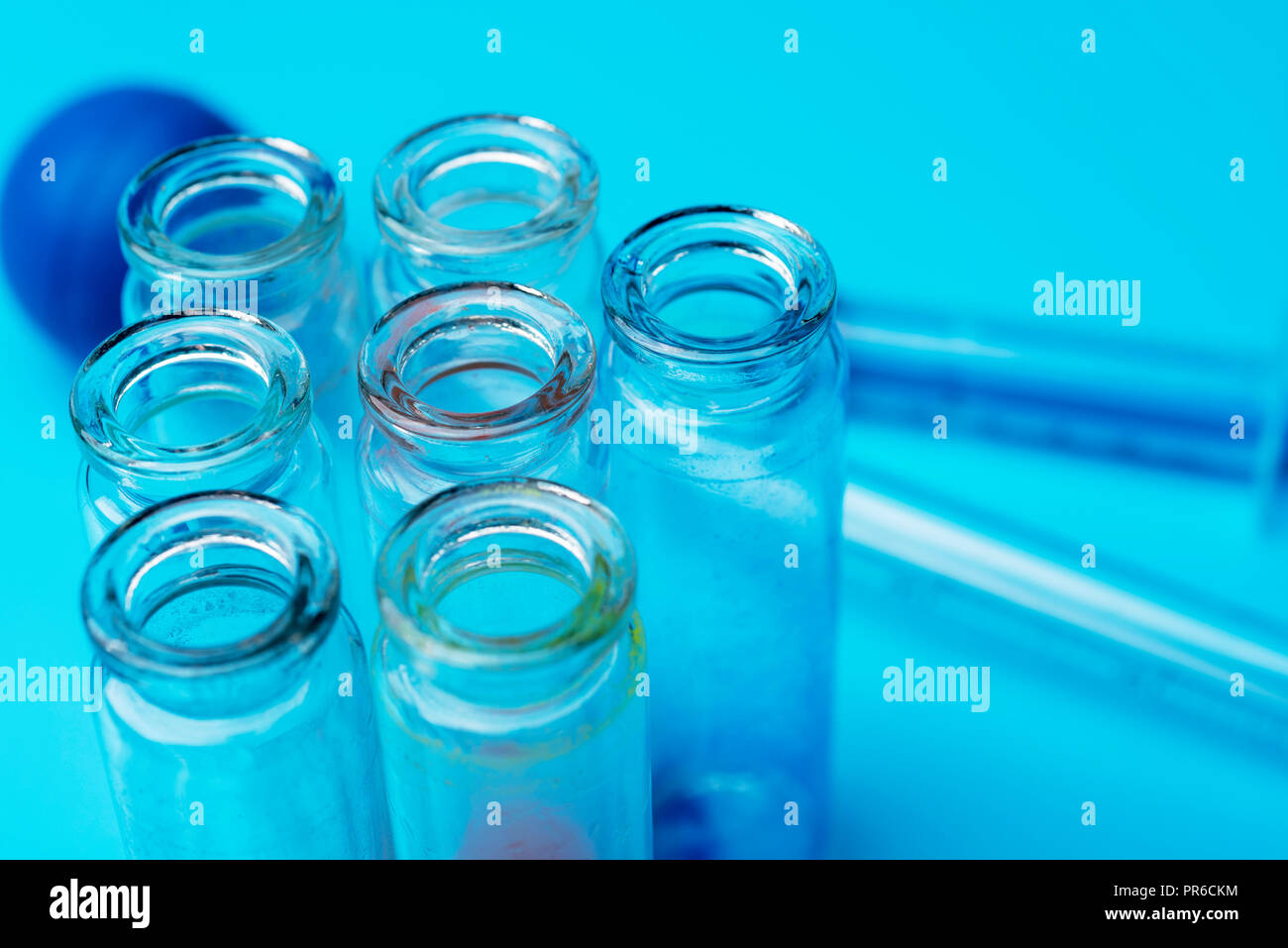Dirty testtubes on blue background. Research in the laboratory Stock