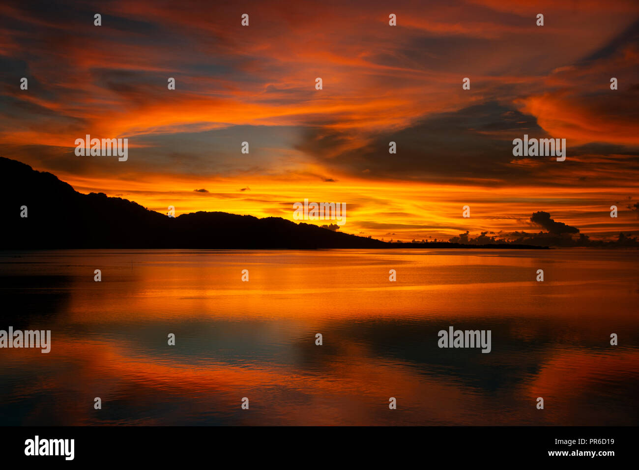 Golden sky with clouds at sunset, U district, Pohnpei, Federated States of Micronesia Stock Photo