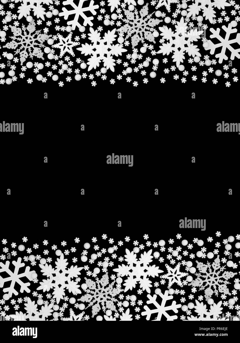 Christmas white snowflake and ball bauble abstract border on black background with copy space. Stock Photo