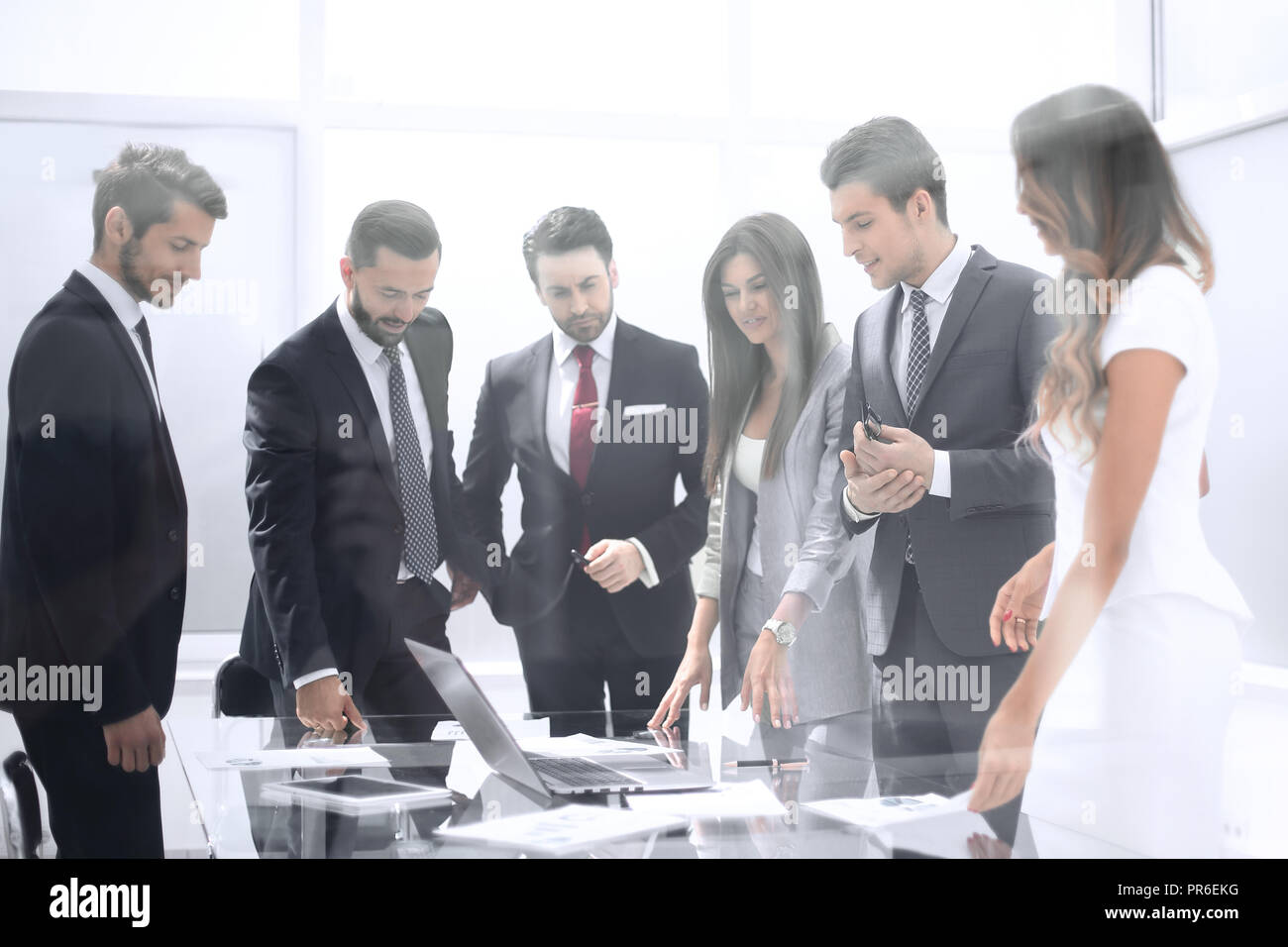 group of business people standing near the negotiating table Stock ...