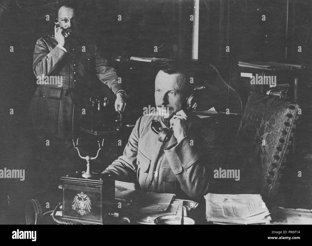 1918 - Armistice - Officers of the Allied Commission at Spa use former Kaiser's phone. French Officer of the Allied Armistice Commission talking through the telephone which the former Kaiser had used Stock Photo