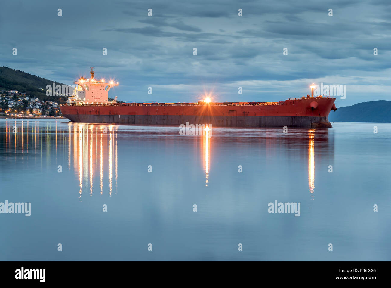 View of a cargo ship anchoring in a port of Narvik to load iron ore, Norway Stock Photo