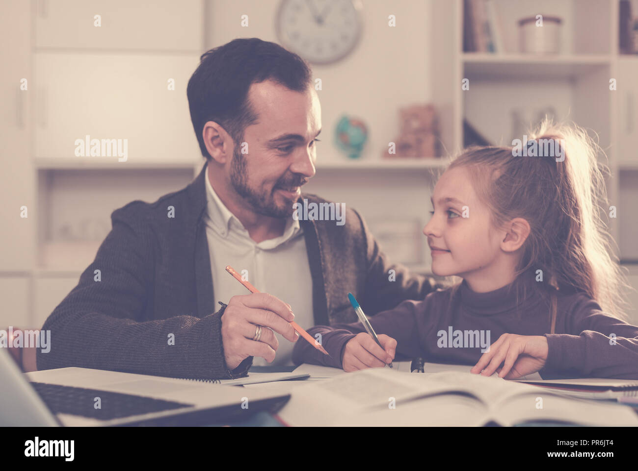Father helping his child to do homework at home Stock Photo - Alamy