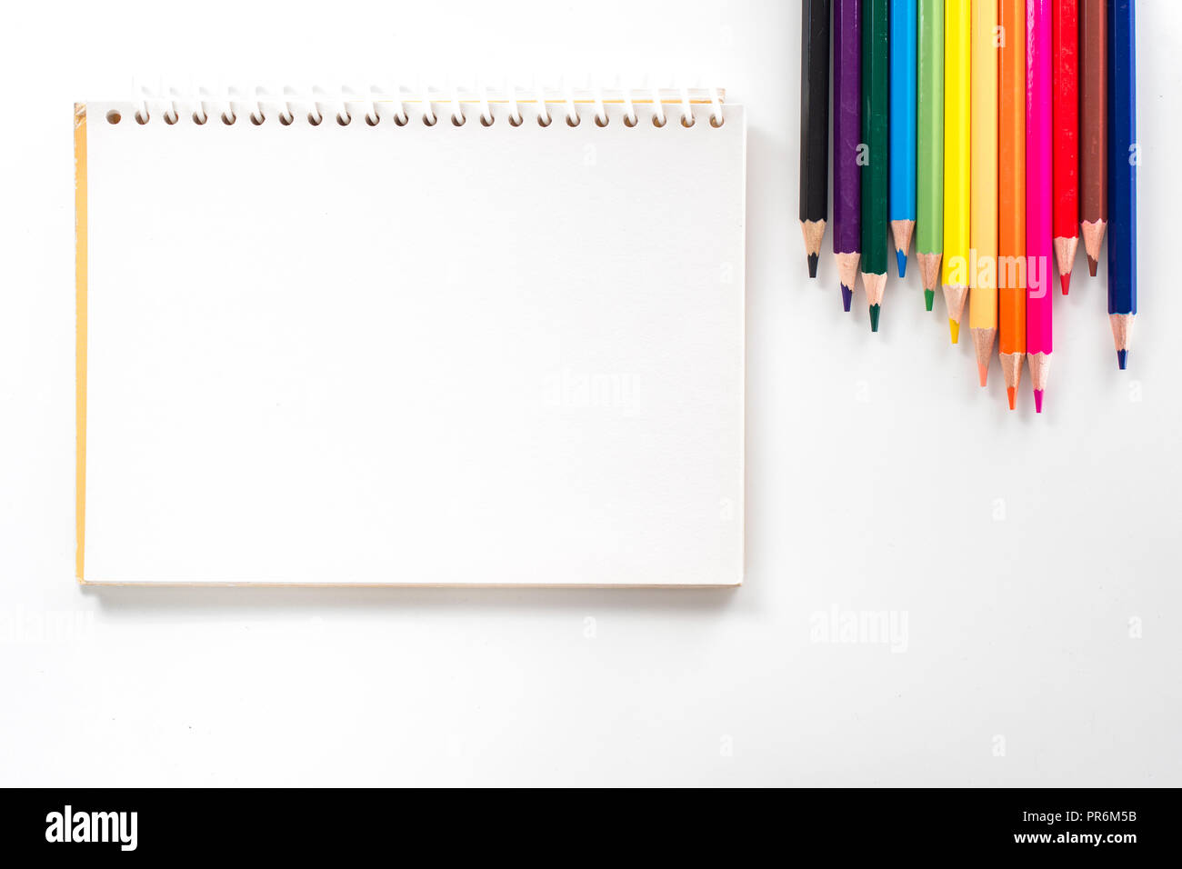 notepad with color pencil on white table view from above Stock Photo ...