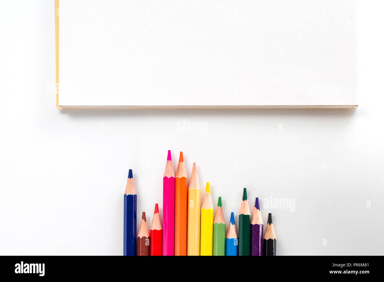 notepad with color pencil on white table view from above Stock Photo ...