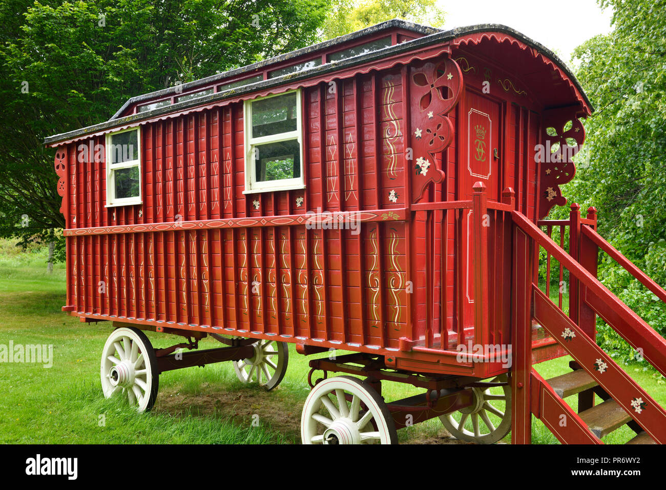 Red painted Gypsy Traveler Caravan parked at Cawdor Castle grounds Nairn Scotland UK Stock Photo