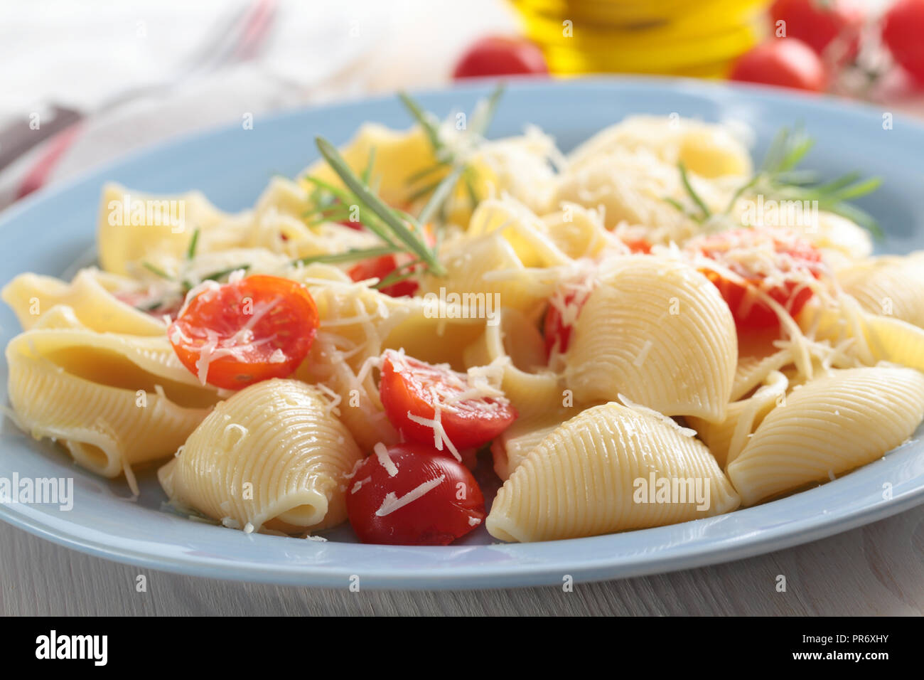Lumaconi with cherry tomato, parmesan cheese, and rosemary Stock Photo