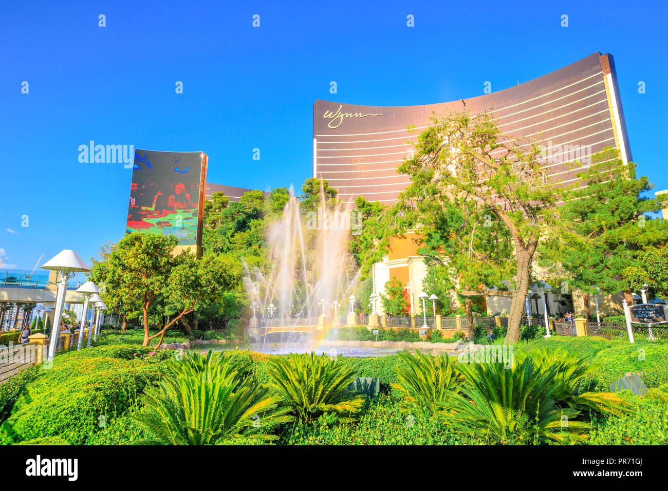 Las Vegas, Nevada, United States - August 18, 2018: Wynn Las Vegas Fountain Show with rainbow in blue sky. The Wynn is Resort Hotel Casino, a 5-star in Las Vegas Strip. Stock Photo