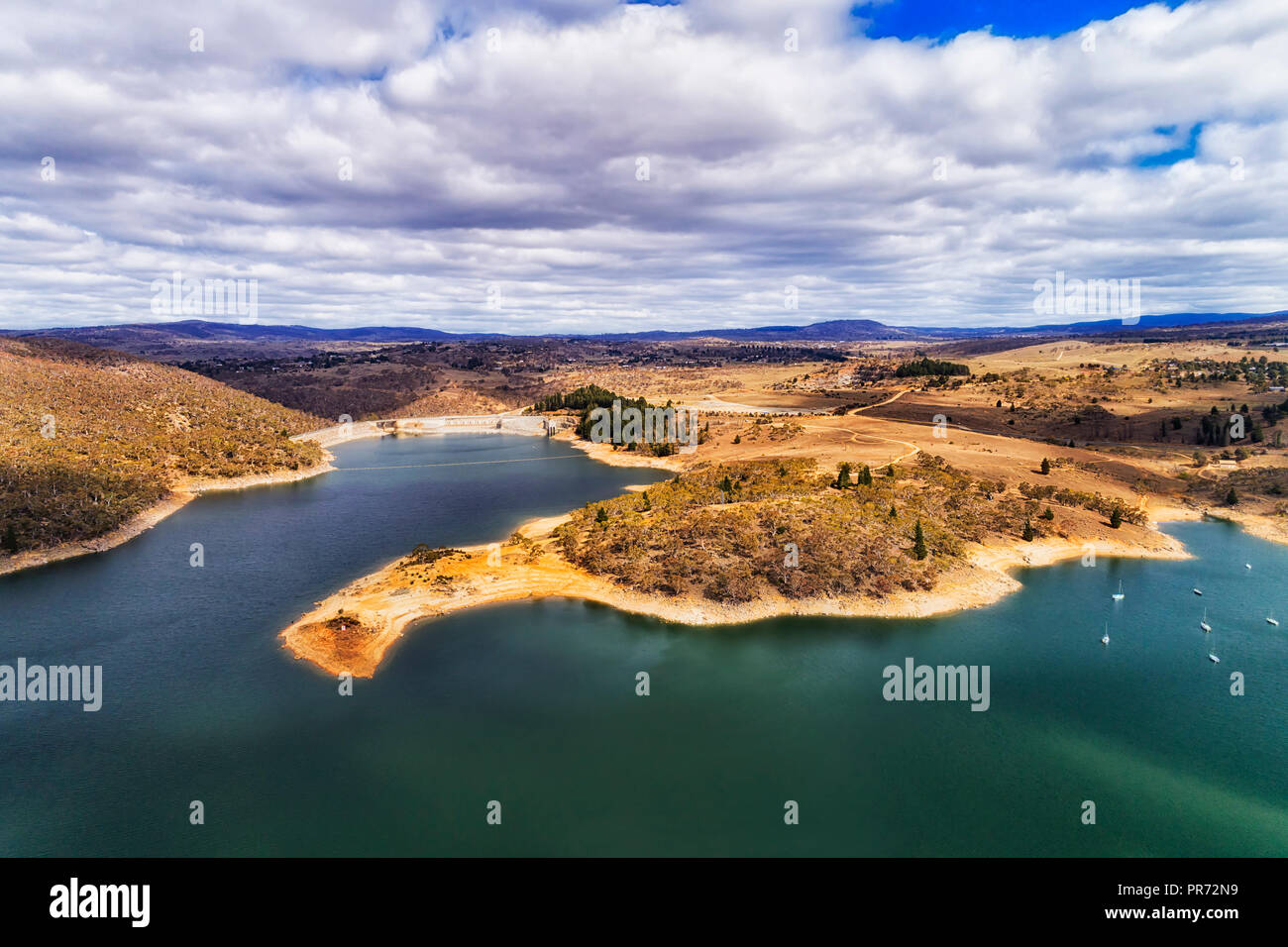 Curved waterfront of Jindabyne lake on Snowy river around dam which