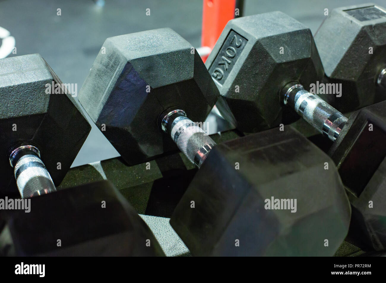 Black rubber dumbbells. Hexagonal heavy duty weight set used for