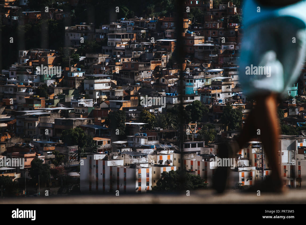 Man looking over the favela of Complexo do alemão in Rio de Janeiro Stock Photo