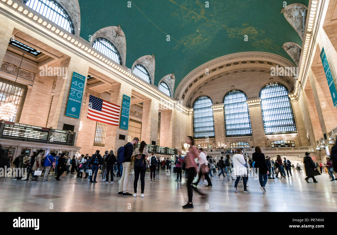 Travelers walk through Grand Central Terminal in New York City. Stock Photo