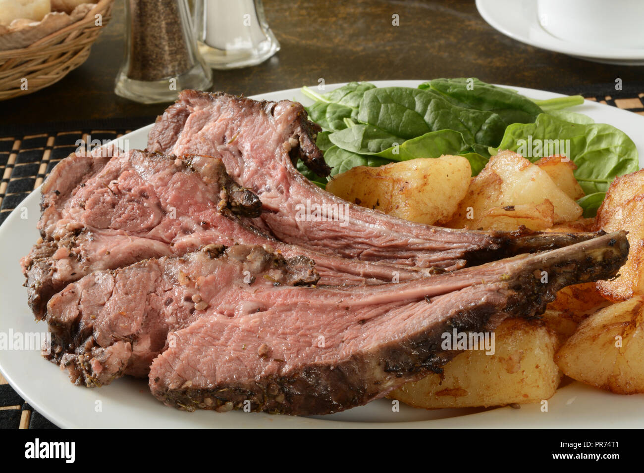 Rack of lamb with fried potatoes and spinach Stock Photo Alamy