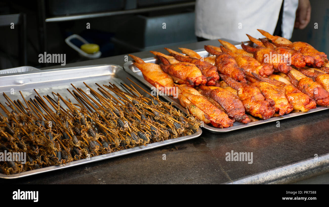 Black scorpions in a stick, exotic snack sold at the Wangfujing Snack Street, Beijing, China Stock Photo