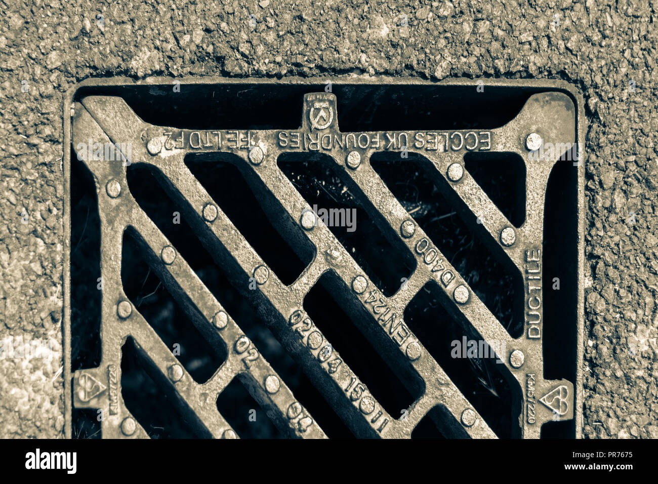 section of a surface water drain on a road Stock Photo
