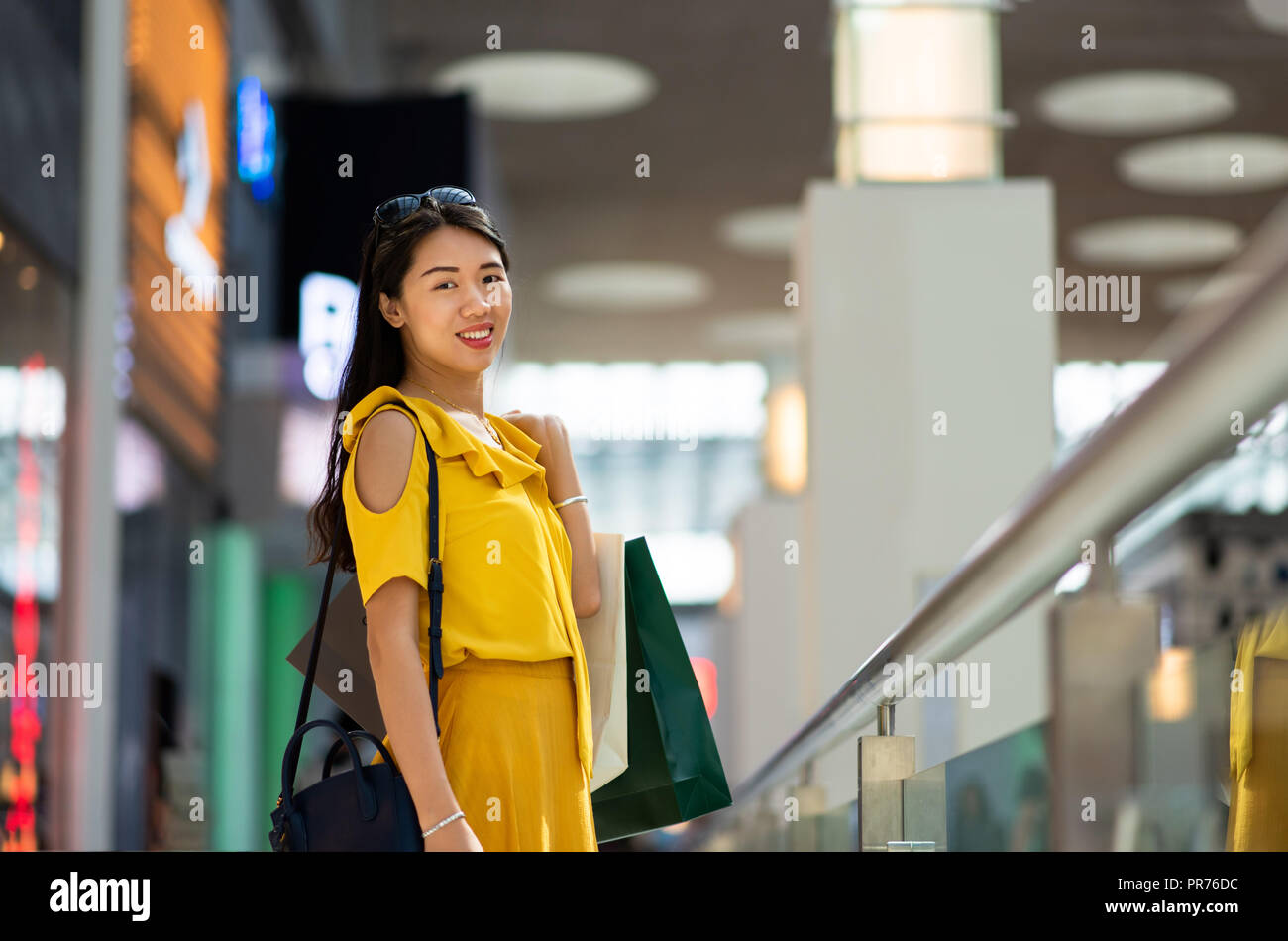 Happy Asian girl in a shopping mall Stock Photo - Alamy
