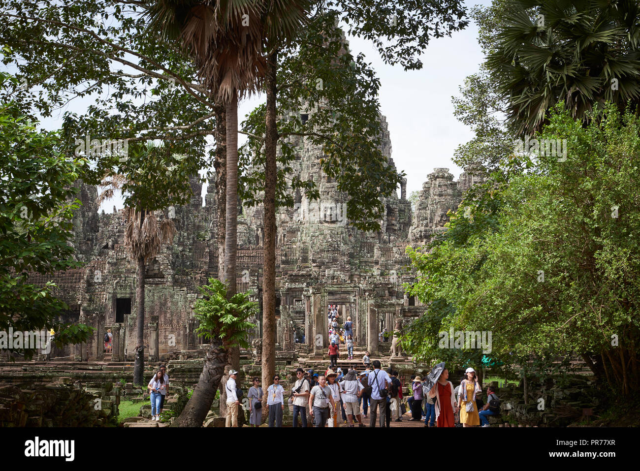 Tourists in Bayon Temple ruins in Angkor Wat. The Angkor Wat complex, Built during the Khmer Empire age, located in Siem Reap, Cambodia, is the larges Stock Photo