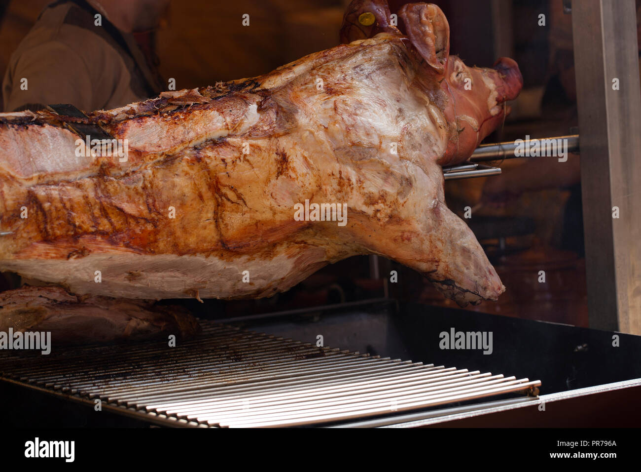Pig on a rotisserie grill Stock Photo Alamy