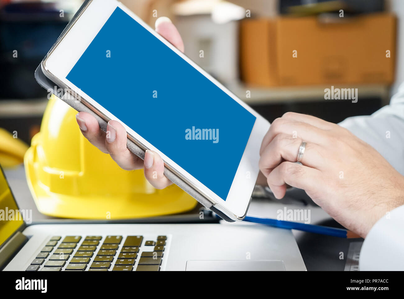 Engineer holding a blank tablet screen for tablet engineering application mock up Stock Photo