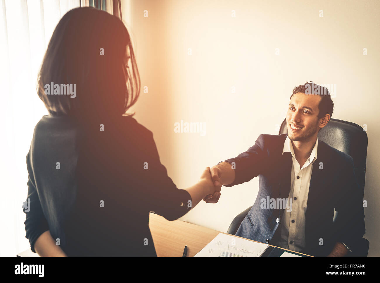 Happy business man is shaking hand closing the deal Stock Photo - Alamy
