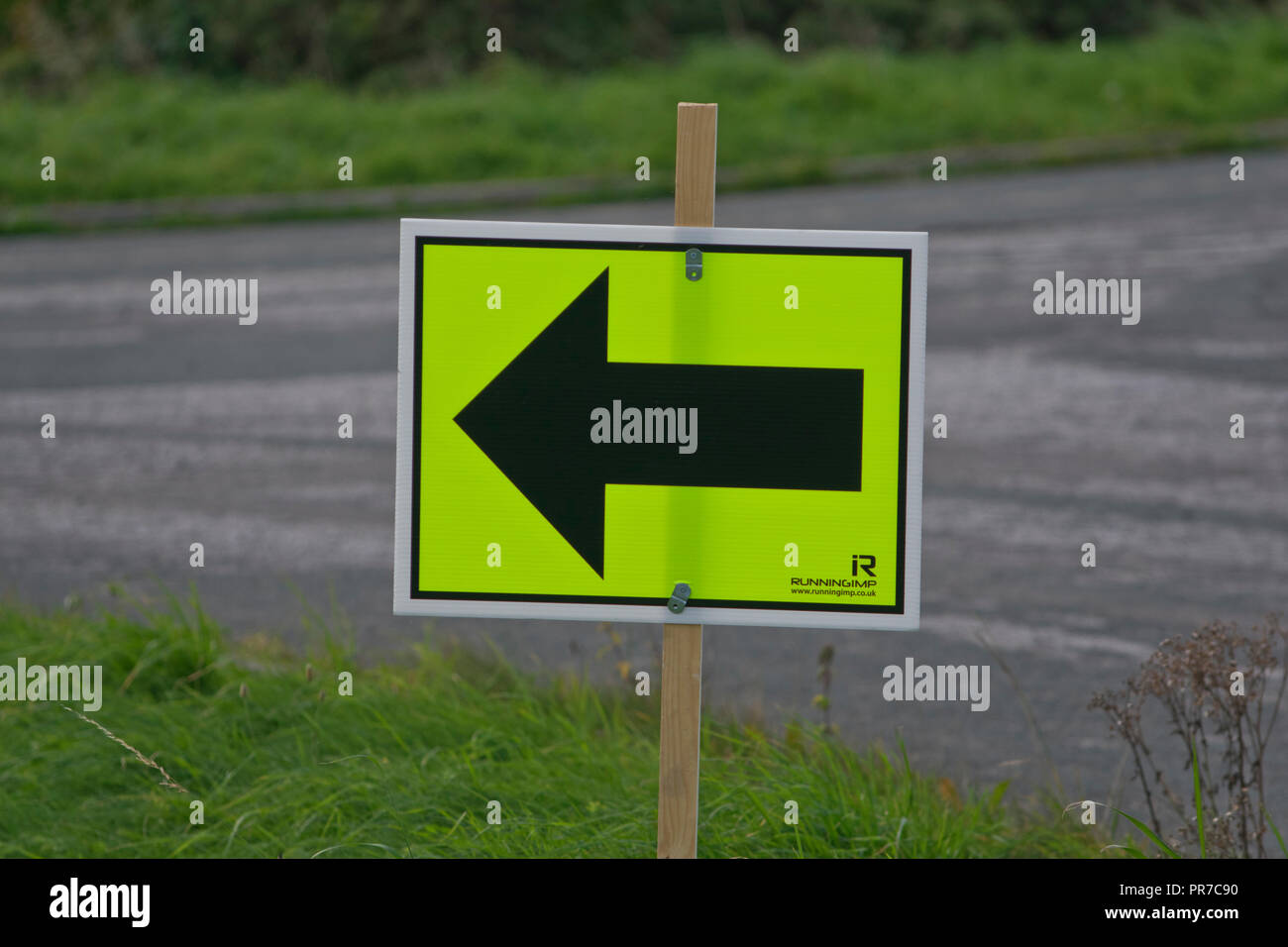 Road Running Race turn left direction sign Stock Photo