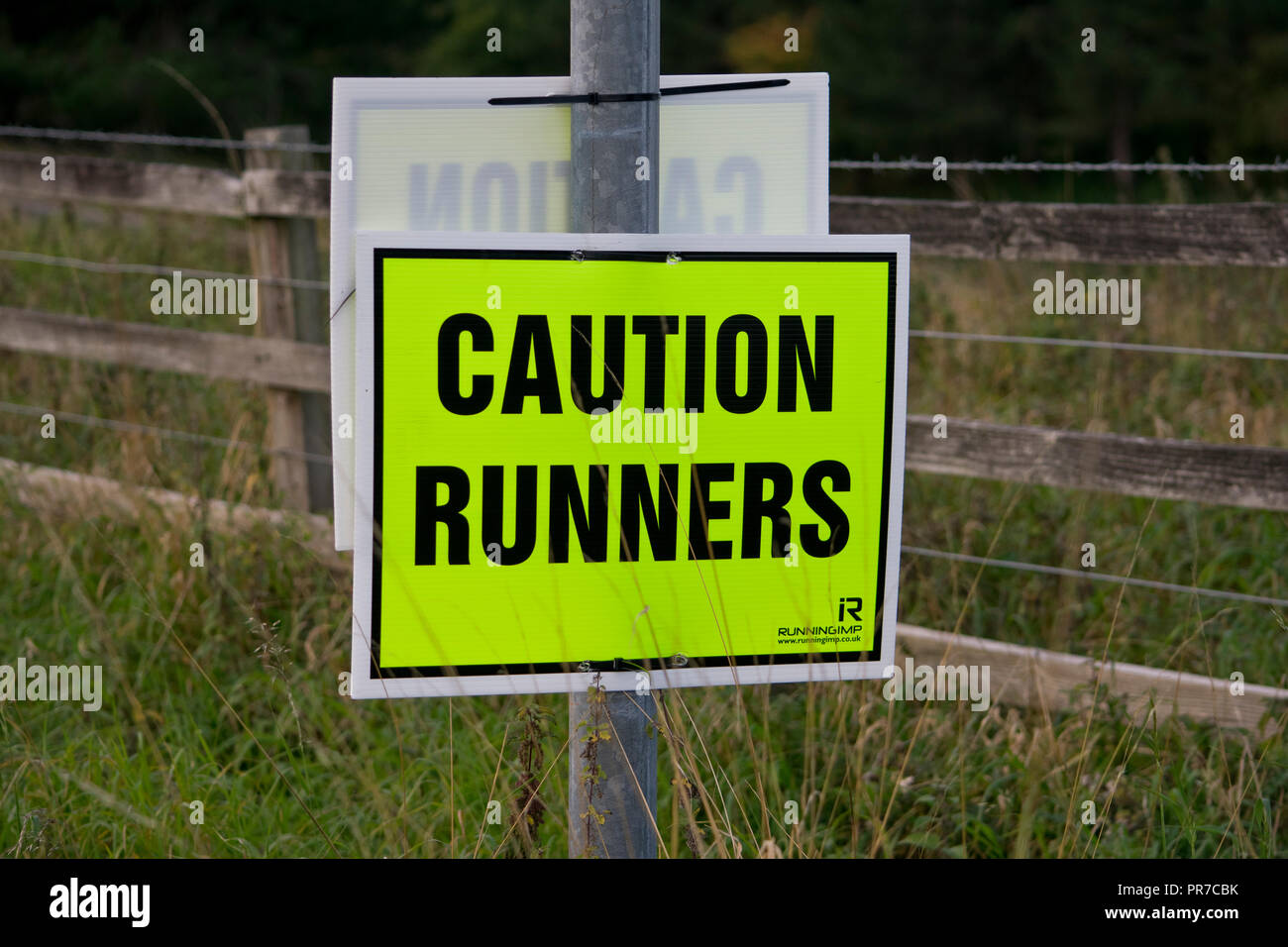 Road Running Race yellow warning sign Stock Photo