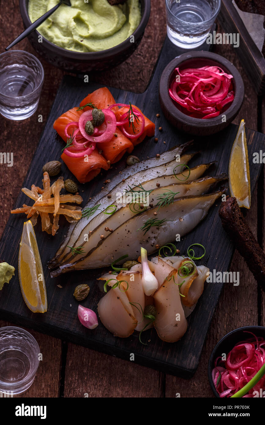 Marinated salmon, cod and halibut with vodka Stock Photo Alamy