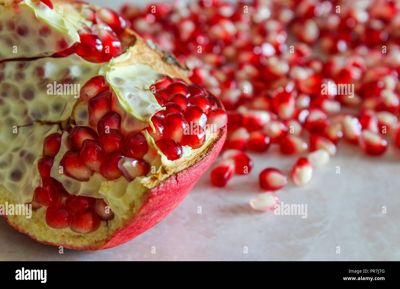 Juicy and fresh pomegranate seeds on table Stock Photo